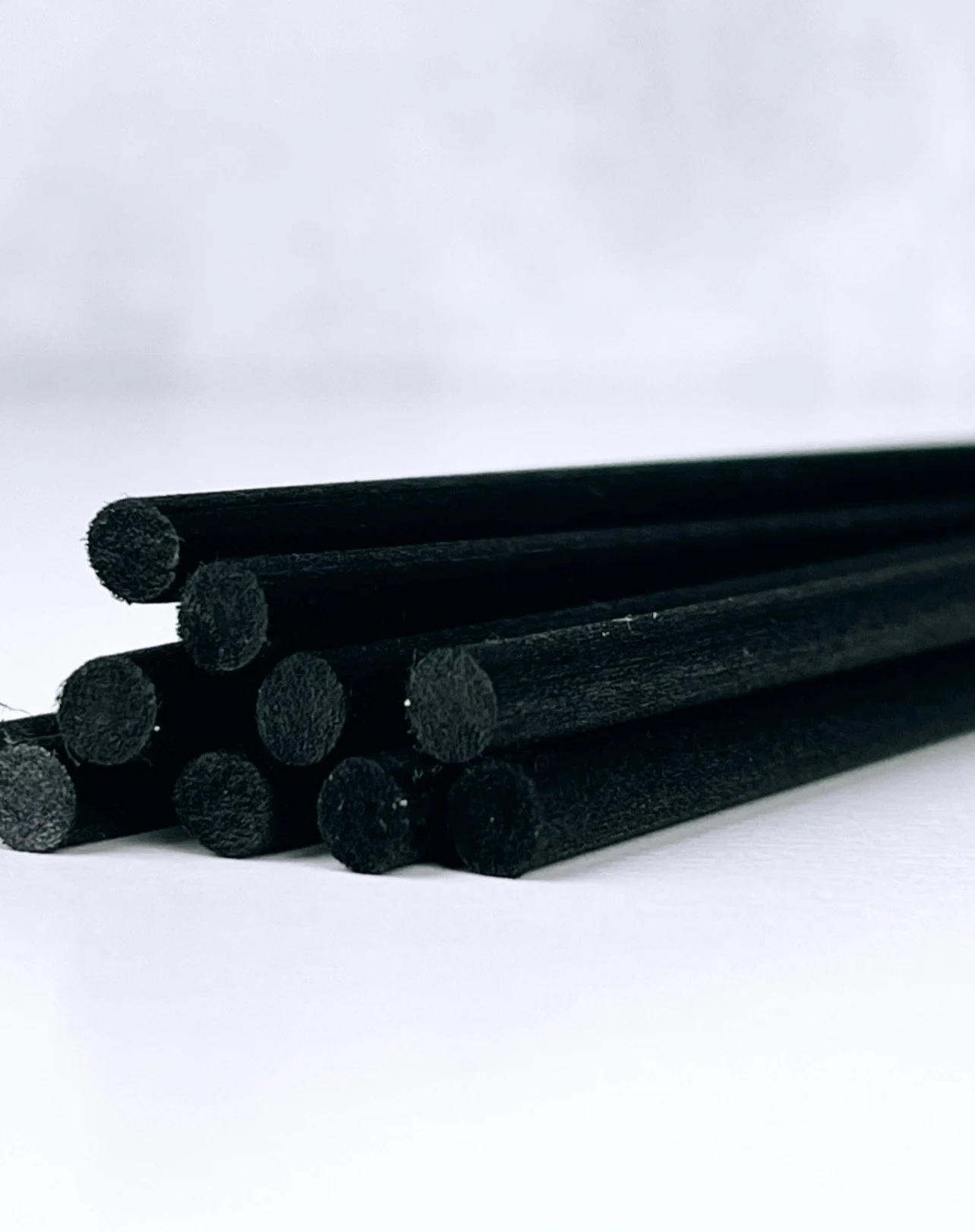 A bunch of black rods are stacked on top of each other